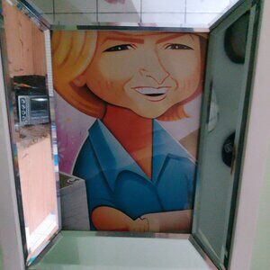 Martha Stewart caricature by Risko in deep set mirrored frame